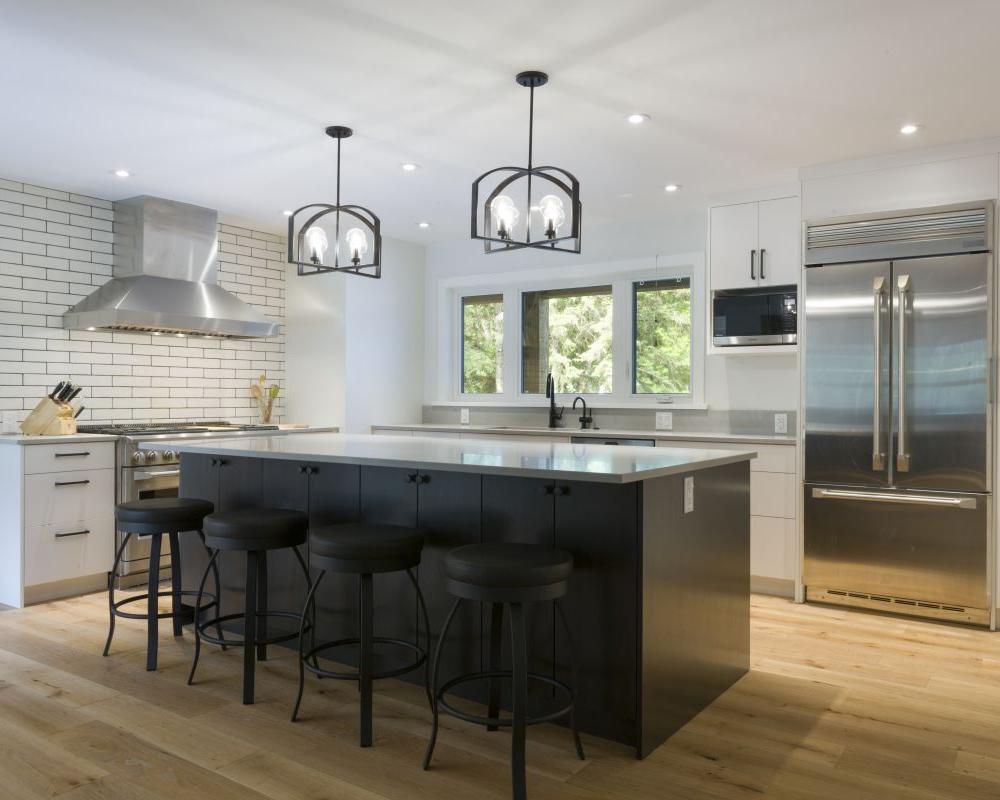 Modern kitchen with a sleek island, statement lighting, and professional-grade appliances. The perfect inspiration for a custom home build or kitchen renovation