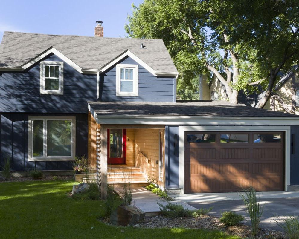 cozy exterior with a mix of classic navy and natural wood finishes