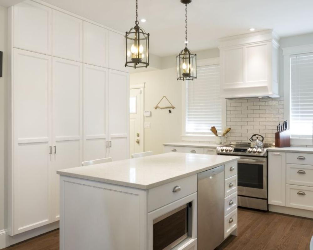 Custom kitchen renovation with white shaker cabinets and silver hardware