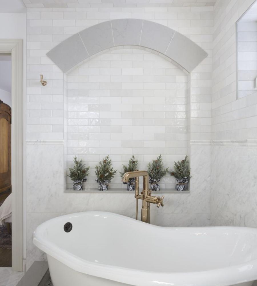 Custom bathroom with deep clawfoot tub and timeless wall tile